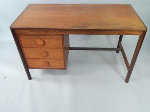 A 1970's teak and crossbanded desk