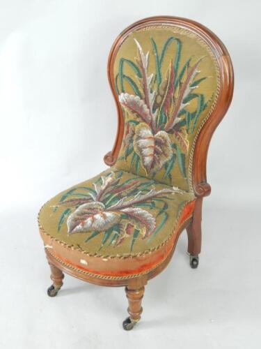 A Victorian mahogany balloon back nursing chair