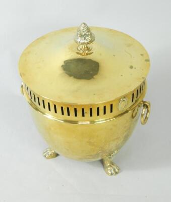 A circular brass coal bucket and cover