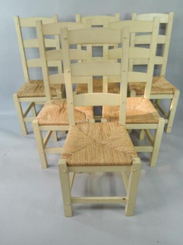 A set of six cream painted ladderback dining chairs