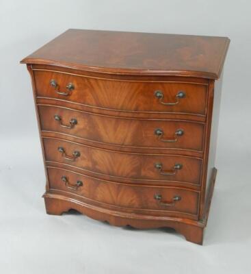 A serpentine mahogany chest of four long drawers