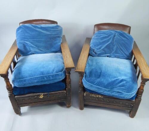 A pair of oak recliner chairs