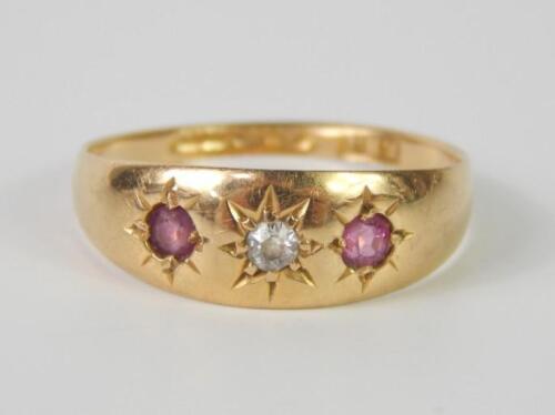An 18ct gold diamond and ruby three stone ring