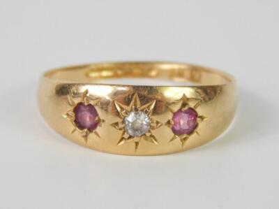 An 18ct gold diamond and ruby three stone ring