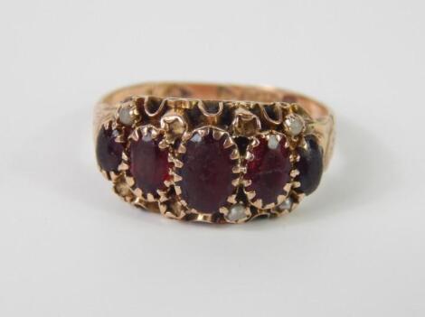 A Victorian 9ct rose gold and garnet five stone ring