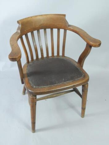 An Edwardian oak lath back captain's chair.