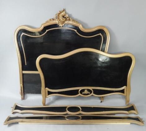 A rococo style giltwood and black painted double bed.