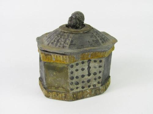 A lead tea caddy with a Blackamoor's head finial to the lid