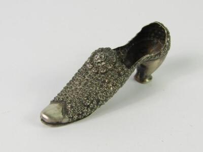 A silver pin cushion modelled as a lady's shoe