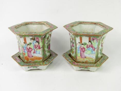 A pair of late 19thC Cantonese famille rose porcelain jardinieres on stands