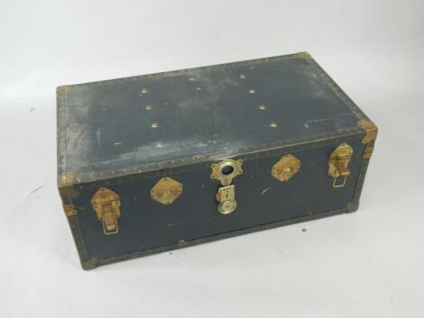 A blue canvas and brass bound trunk