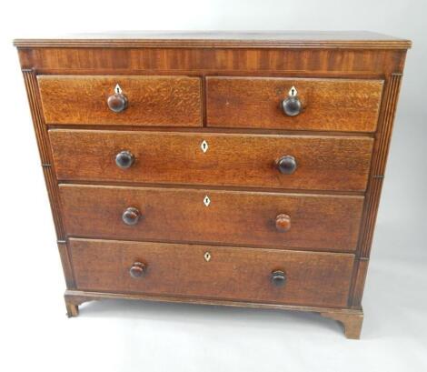 A Georgian oak and mahogany chest of drawers