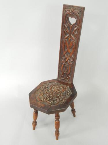 An oak spinning chair carved with Celtic Knot motifs
