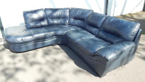 A blue leather six seater curved corner sofa.