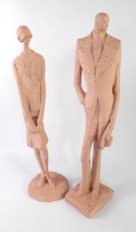 A pair of pink painted plaster 1974 Austin production figures of a 1930's Gatsby man and woman