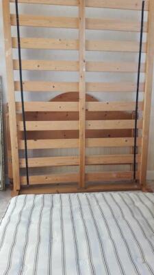 A modern pine double bedstead.