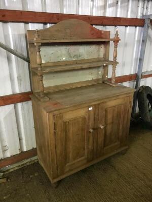 A pine two door cupboard and mirror back.