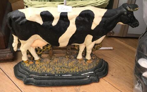 A cast iron cow door stop.