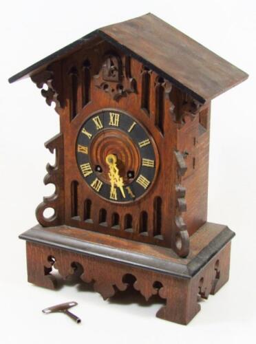 An early 20thC Swiss Black Forest oak mantel cuckoo clock