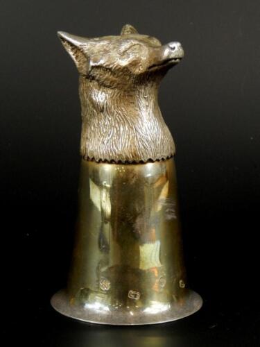 A modern silver stirrup cup cast with the head of a fox