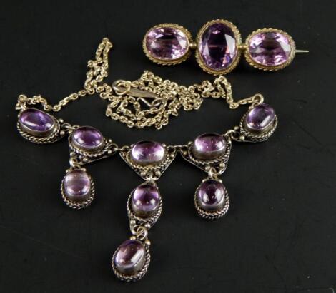 A silver necklace and brooch set