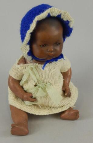 An Armand Marseille black bisque headed doll