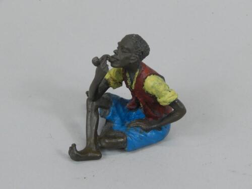 A Cold painted bronze figure of a seated Arab smoking a pipe