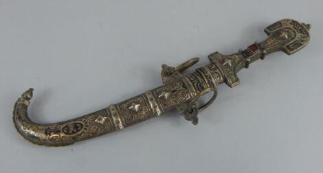 A Middle Eastern white metal and brass ceremonial dagger