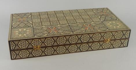 A late 20thC Damascus type mother of pearl and bone inlaid backgammon box