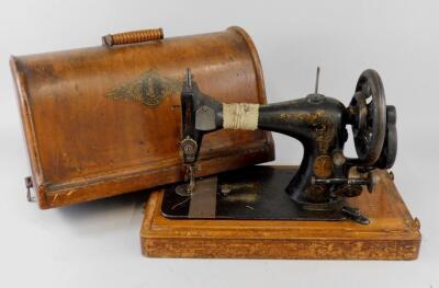 A Singer sewing machine in walnut veneered domed case.