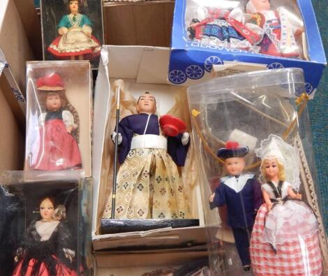 Approximately twenty eight costume dolls