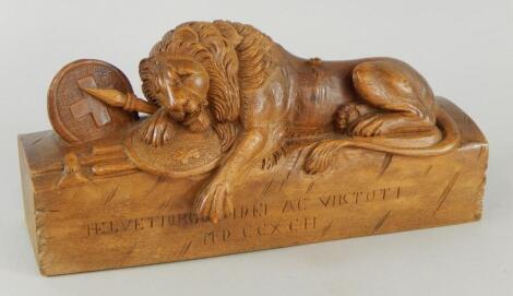 A 20thC carved commemorative boxwood Lucerne military lion group