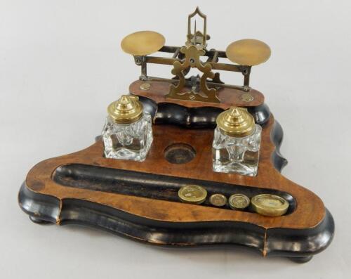 An Edwardian walnut and ebonised desk stand