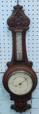 An Edwardian oak cased barometer and thermometer