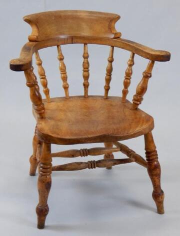 A late 19thC stripped ash and elm captain's chair