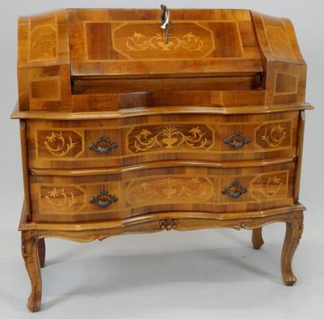 A walnut and part inlaid Continental serpentine bureau