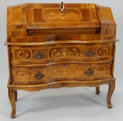 A walnut and part inlaid Continental serpentine bureau