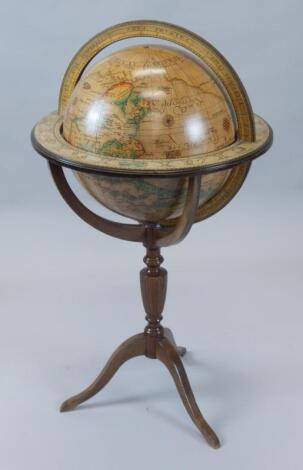 A modern terrestrial globe and mahogany finish stand