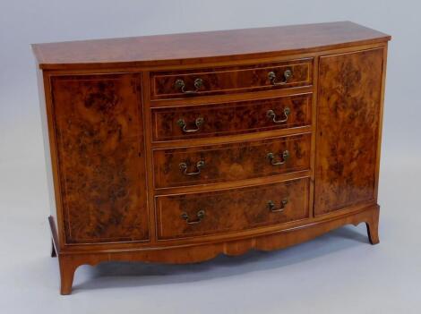 A yew veneered bow fronted sideboard