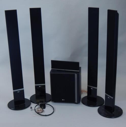 Four modern LG upright surround sound speakers