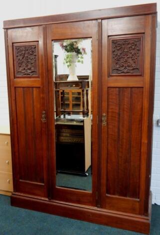 An Edwardian walnut double wardrobe