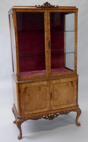 A 20thC walnut display cabinet