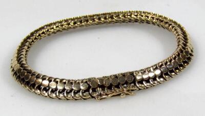 A yellow metal fancy link flexible bracelet