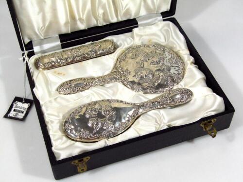 A silver mounted three piece part dressing table set