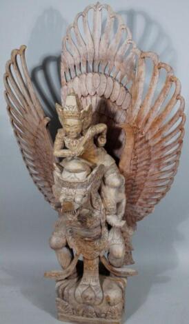 A modern wooden carving of an Indian god group