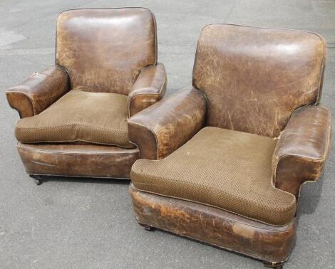 A pair of early 20thC deep leather library armchairs