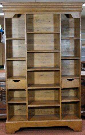 A light oak freestanding open bookcase