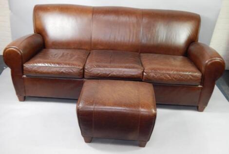 A brown leather three seater sofa