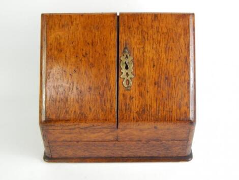 A Victorian oak stationery rack