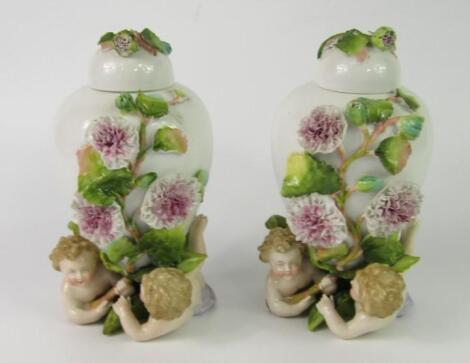 A pair of German porcelain oviform vases and covers